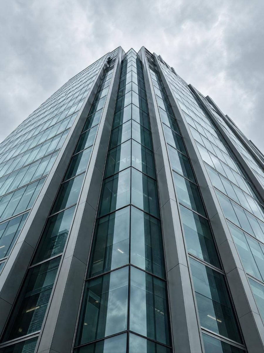 Looking up at a modern glass office building